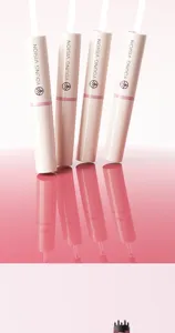 Detail view of pink dual-ended liquid blush and freckle pens with sleek cosmetic design.