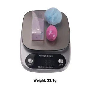 Cute egg-shaped lip mask with fluffy pom-pom keychain, moisturizing fruit formula for soft lips.