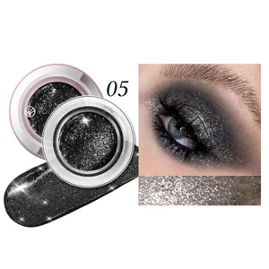 Black glitter eyeshadow makeup pot detail view showing sparkling cosmetic texture and application.