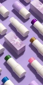 Detail view of colorful glitter stick cosmetic with sparkling makeup powder in various shades.