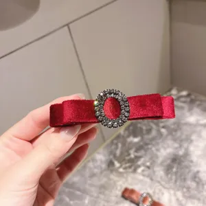Red velvet hair clip with rhinestone oval buckle, elegant vintage bow hair accessory for women.