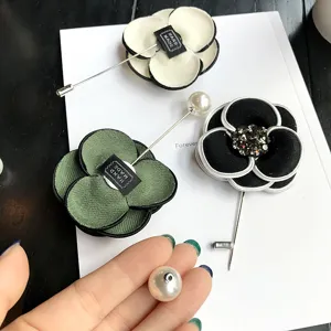Elegant retro camellia flower brooch pin with sparkling rhinestones and pearl accents for women.