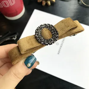 Elegant brown velvet bow hair clip with sparkling rhinestone oval buckle for women and girls.