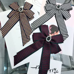 Chic houndstooth bow brooch with crystal center, elegant shirt collar pin for women.