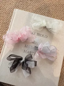 Detailed view of Korean style mesh bow hair clips, elegant duckbill clips, soft and chic design.