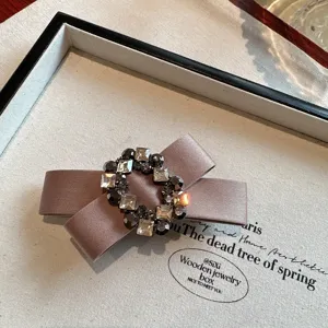 Detailed view of an elegant Korean style rhinestone bow hair clip, vintage black accessory.