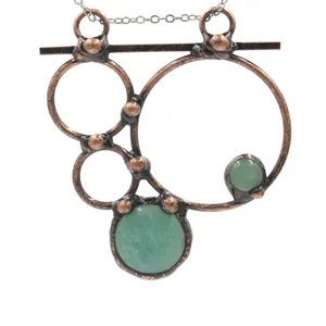 Retro bronze geometric gemstone pendant necklace detail close-up showcasing the unique metallic texture.