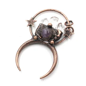 Crystal quartz and crescent moon pendant detail closeup view, vintage copper alloy jewelry accessory.
