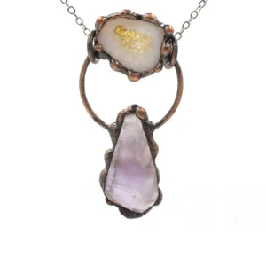 Raw crystal gemstone and copper wire wrapped pendant detail, vintage handcrafted necklace close up