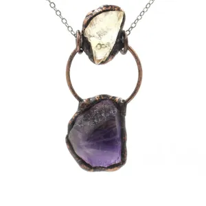 Handmade raw crystal copper pendant necklace featuring natural purple and light stone details.