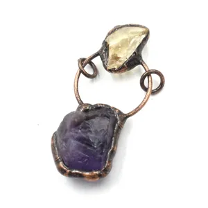 Detailed view of handmade raw amethyst and citrine crystal pendant with vintage copper wire wrap.