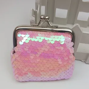 Close-up view of pink iridescent sequin coin purse, featuring metallic kiss-lock closure.