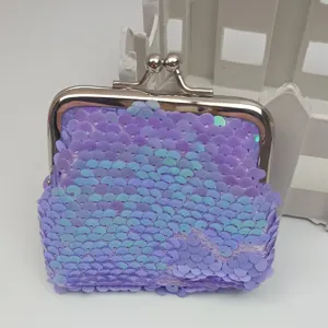 Detailed shot of a 3-inch purple iridescent sequin coin purse with a metal kiss-lock clasp.