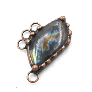 Close-up of vintage labradorite raw stone copper electroformed pendant DIY jewelry finding.