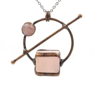 Vintage copper rose quartz pendant necklace detail showing unique geometric stone design.