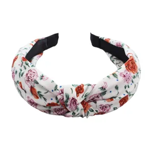 Cute floral knotted headband, fabric wide hair hoop for women, stylish floral hair accessory.