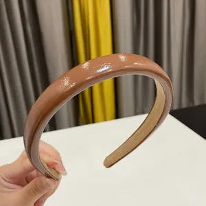 Glossy brown PU leather headband for women, retro wide hair hoop for daily fashion wear.