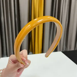 Glossy yellow PU leather headband detail, thick padded hair hoop for women daily wear.