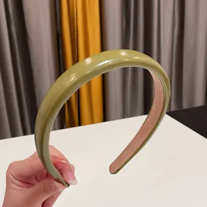Glossy olive green headband for women, stylish high cranial top PU leather hair hoop detail.
