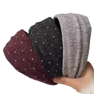 Detail view of the soft knitted wide headband featuring cute small polka dots for women.