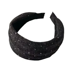 Detailed close-up view of the black knitted wide headband featuring silver polka dots.