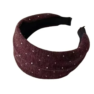 Knotted vintage polka dot knitted wide hair band detail view, soft autumn winter hair accessory.
