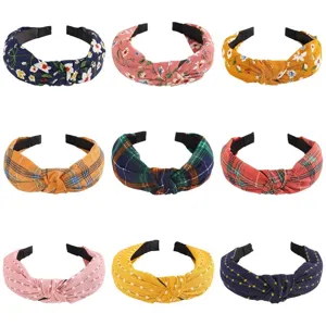 Detailed close-up view of multiple vintage fabric knotted headbands in stylish prints.