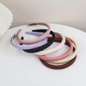 Close-up detail of multi-color satin hair bands, featuring smooth texture and neat stitching.