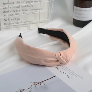 Pink suede knotted headband for women, elegant wide hair hoop, comfortable daily accessory.