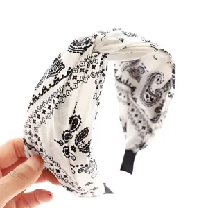 Vintage paisley wide headband for women, stylish black and white fabric hair accessory.