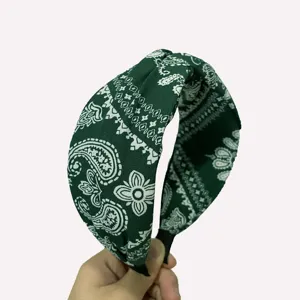 Green paisley headband detail, wide fabric hair hoop showcasing the classic vintage print.