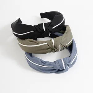 Detailed view of the Korean style cloth cross knotted headband with elegant white piping.