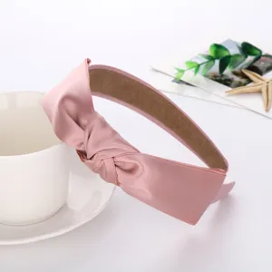Pink satin knotted headband detail shot, minimalist daily hair accessory, elegant look.