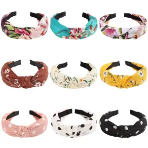 Detailed view of fashionable retro fabric knotted headbands with floral and polka dot patterns.