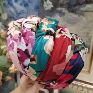 Vintage floral knotted headband for women, wide fabric hair hoop, stylish daily hair accessory.