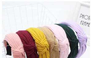 Detailed view of colorful knitted wide cross headbands, soft textured hair accessories set.