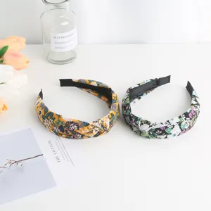 Detail view of sweet floral knotted hairbands, featuring colorful botanical prints for women.