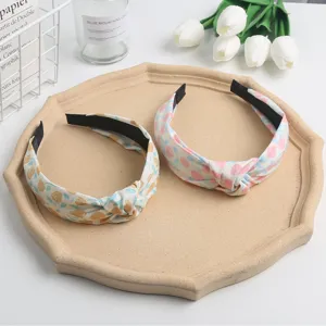 Detail view of sweet floral knotted headbands, fabric hair hoops in fresh spring designs.