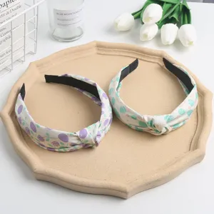 Sweet floral knotted fabric headband detail, soft material, fresh and cute everyday accessory.