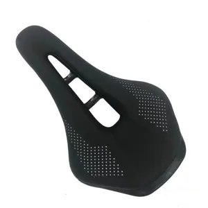 Detailed view of black short-nose bicycle saddle with hollow ventilation design and perforated pattern.