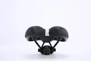 Comfortable thick bicycle saddle with shock absorption and rear reflector for mountain bikes.