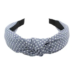 Close-up detail view of blue fabric polka dot hair hoop with stylish knotted design.