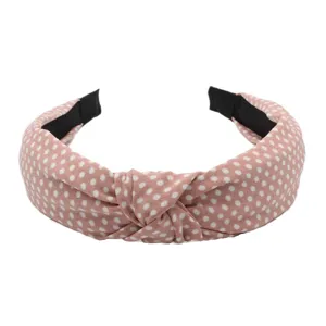 Pink polka dot headband with knotted design, stylish cloth hair hoop detail view for daily wear.