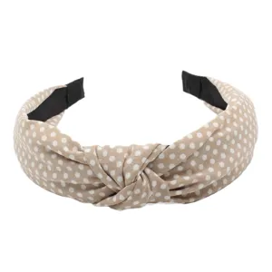 Chic polka dot knotted headband for women, stylish wide fabric hair hoop accessory.