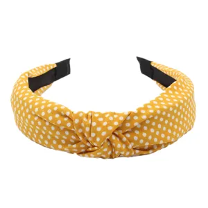 Yellow polka dot fabric headband detail, stylish knotted hair hoop for women daily wear.