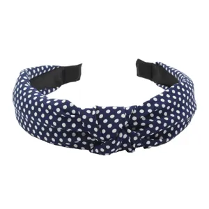 Detailed view of the blue polka dot knotted fabric headband, showing neat fabric texture and close-up design.