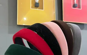 Detailed view of multiple retro French flocked wide brim headbands in various colors.
