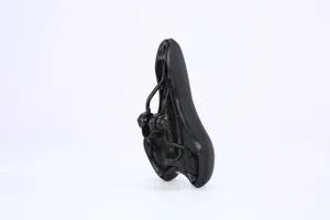 Detail view of black bicycle saddle bottom structure with shock-absorbing rails and clamp.