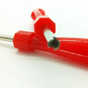 Detail shot of red handle valve core wrench and tire deflation tool for maintenance