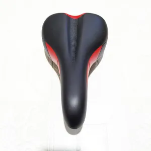 Detail view of black and red bicycle saddle cushion, featuring ergonomic central groove.